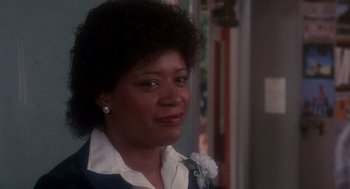 Movie still from “Mask” (1985), directed by Peter Bogdanovich – A person wearing a suit and tie; Close Up shot, Low angle