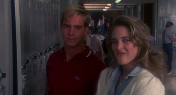 Movie still from “Mask” (1985), directed by Peter Bogdanovich – A man and a woman standing next to each other; Medium shot, Low angle