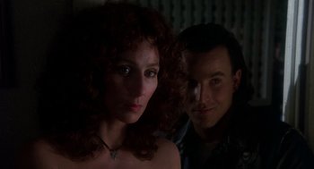 Movie still from “Mask” (1985), directed by Peter Bogdanovich – A man and a woman posing for a picture; Close Up shot, Low angle