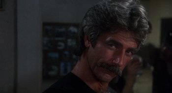 Movie still from “Mask” (1985), directed by Peter Bogdanovich – A person with a mustache; Close Up shot, Over the shoulder angle
