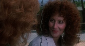 Movie still from “Mask” (1985), directed by Peter Bogdanovich – A person with long curly red hair; Close Up shot, Over the shoulder angle