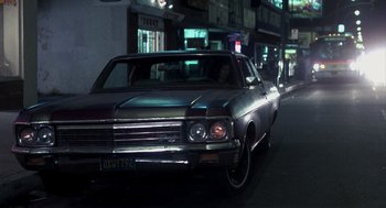 Movie still from “Mask” (1985), directed by Peter Bogdanovich – An old car parked on the side of the street; Wide shot, Low angle