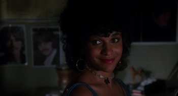 Movie still from “Mask” (1985), directed by Peter Bogdanovich – A person wearing a necklace; Close Up shot, Over the shoulder angle