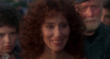 Movie still from “Mask” (1985), directed by Peter Bogdanovich – A person with curly red hair; Close Up shot, Over the shoulder angle