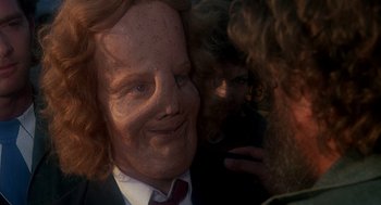 Movie still from “Mask” (1985), directed by Peter Bogdanovich – A man in a suit and tie is looking at another man in a suit and tie; Close Up shot, Over the shoulder angle