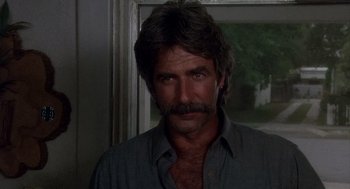 Movie still from “Mask” (1985), directed by Peter Bogdanovich – A person wearing a shirt; Close Up shot, Low angle