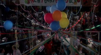 Movie still from “Mask” (1985), directed by Peter Bogdanovich – A bunch of balloons hanging from the ceiling of a party; Wide shot, Overhead angle