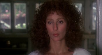Movie still from “Mask” (1985), directed by Peter Bogdanovich – A person with curly hair; Close Up shot, Over the shoulder angle