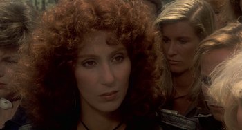 Movie still from “Mask” (1985), directed by Peter Bogdanovich – A woman with red curly hair is looking at the camera; Close Up shot, Over the shoulder angle