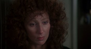 Movie still from “Mask” (1985), directed by Peter Bogdanovich – A person with curly red hair; Close Up shot, Over the shoulder angle