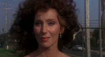 Movie still from “Mask” (1985), directed by Peter Bogdanovich – A person wearing a dress; Close Up shot, Over the shoulder angle