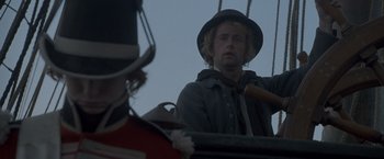 Movie still from “Master and Commander: The Far Side of the World” (2003), directed by Peter Weir – A man wearing a hat and a uniform; Close Up shot, Low angle