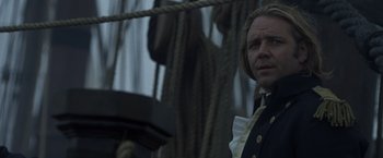 Movie still from “Master and Commander: The Far Side of the World” (2003), directed by Peter Weir – A person on a boat in the water; Close Up shot, Over the shoulder angle