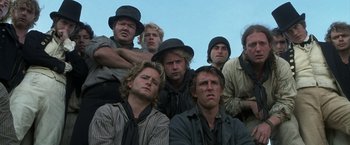 Movie still from “Master and Commander: The Far Side of the World” (2003), directed by Peter Weir – A group of men wearing hats and ties; Medium shot, Low angle
