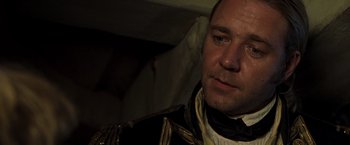 Movie still from “Master and Commander: The Far Side of the World” (2003), directed by Peter Weir – A person wearing a suit and tie; Close Up shot, Over the shoulder angle