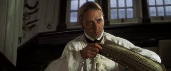 Movie still from “Master and Commander: The Far Side of the World” (2003), directed by Peter Weir – A person wearing a shirt and tie; Close Up shot, Low angle
