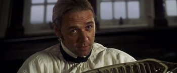 Movie still from “Master and Commander: The Far Side of the World” (2003), directed by Peter Weir – A person wearing a shirt and bow tie; Close Up shot, Over the shoulder angle