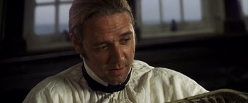 Movie still from “Master and Commander: The Far Side of the World” (2003), directed by Peter Weir – A person wearing a shirt and tie; Close Up shot, Over the shoulder angle