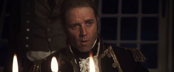 Movie still from “Master and Commander: The Far Side of the World” (2003), directed by Peter Weir – A person with a candle in a room; Close Up shot, High angle