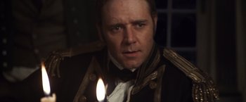 Movie still from “Master and Commander: The Far Side of the World” (2003), directed by Peter Weir – A person holding a lit candle; Close Up shot, Over the shoulder angle