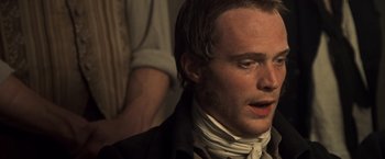 Movie still from “Master and Commander: The Far Side of the World” (2003), directed by Peter Weir – A person wearing a suit and tie; Close Up shot, High angle