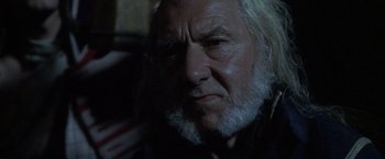 Movie still from “Master and Commander: The Far Side of the World” (2003), directed by Peter Weir – An old man with a beard is looking at the camera; Close Up shot, Low angle
