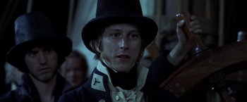 Movie still from “Master and Commander: The Far Side of the World” (2003), directed by Peter Weir – A person wearing a hat; Close Up shot, Over the shoulder angle