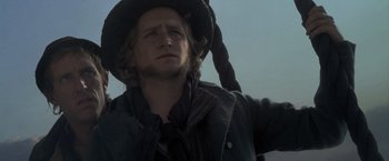 Movie still from “Master and Commander: The Far Side of the World” (2003), directed by Peter Weir – A man in a hat and a long rope; Close Up shot, Low angle