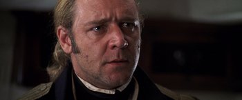 Movie still from “Master and Commander: The Far Side of the World” (2003), directed by Peter Weir – A person wearing a suit and tie; Close Up shot, Over the shoulder angle