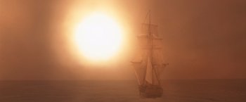 Movie still from “Master and Commander: The Far Side of the World” (2003), directed by Peter Weir – A sail boat sailing on a body of water at sunset; Extreme Wide shot, Low angle