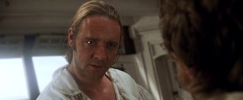 Movie still from “Master and Commander: The Far Side of the World” (2003), directed by Peter Weir – A person wearing a white shirt; Close Up shot, Over the shoulder angle