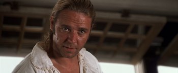 Movie still from “Master and Commander: The Far Side of the World” (2003), directed by Peter Weir – A person wearing a white shirt; Close Up shot, Low angle