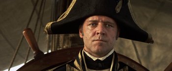 Movie still from “Master and Commander: The Far Side of the World” (2003), directed by Peter Weir – A person wearing a hat; Close Up shot, Low angle