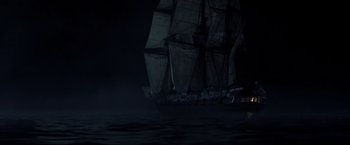 Movie still from “Master and Commander: The Far Side of the World” (2003), directed by Peter Weir – A large sail boat in the middle of the night; Extreme Wide shot, Over the shoulder angle