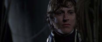 Movie still from “Master and Commander: The Far Side of the World” (2003), directed by Peter Weir – A person wearing a black and white uniform; Close Up shot, Low angle