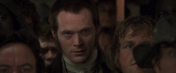 Movie still from “Master and Commander: The Far Side of the World” (2003), directed by Peter Weir – A person wearing a shirt; Close Up shot, Over the shoulder angle