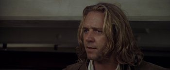 Movie still from “Master and Commander: The Far Side of the World” (2003), directed by Peter Weir – A person with long blonde hair; Close Up shot, Over the shoulder angle