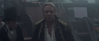 Movie still from “Master and Commander: The Far Side of the World” (2003), directed by Peter Weir – A person wearing a jacket; Close Up shot, Over the shoulder angle