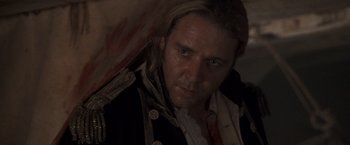 Movie still from “Master and Commander: The Far Side of the World” (2003), directed by Peter Weir – A person wearing a pirate costume; Close Up shot, High angle