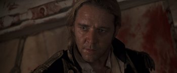 Movie still from “Master and Commander: The Far Side of the World” (2003), directed by Peter Weir – A person wearing a jacket; Close Up shot, Over the shoulder angle