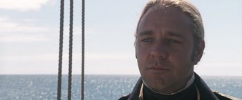 Movie still from “Master and Commander: The Far Side of the World” (2003), directed by Peter Weir – A person on a boat in the water; Close Up shot, Low angle