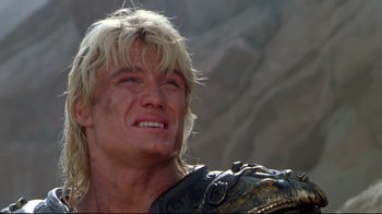 Movie still from “Masters of the Universe” (1987), directed by Gary Goddard – A person with long blonde hair; Close Up shot, Low angle