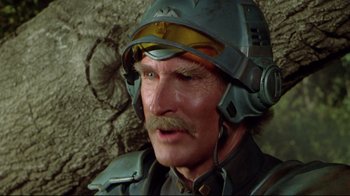 Movie still from “Masters of the Universe” (1987), directed by Gary Goddard – An older man with a mustache and a helmet on; Close Up shot, High angle