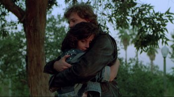 Movie still from “Masters of the Universe” (1987), directed by Gary Goddard – A man and a woman hugging in a forest; Medium shot, Low angle
