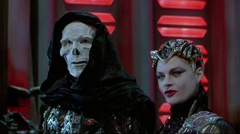 Movie still from “Masters of the Universe” (1987), directed by Gary Goddard – A couple of people standing next to each other; Close Up shot, Low angle