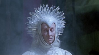 Movie still from “Masters of the Universe” (1987), directed by Gary Goddard – A man in a white costume with a crystal head piece; Close Up shot, Low angle
