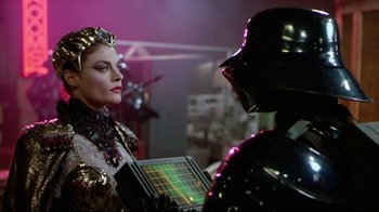 Movie still from “Masters of the Universe” (1987), directed by Gary Goddard – A woman and a man dressed as darth vader; Medium shot, Over the shoulder angle