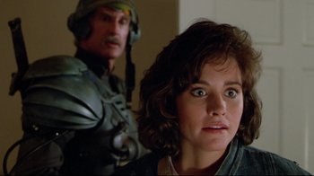 Movie still from “Masters of the Universe” (1987), directed by Gary Goddard – A man and a woman are looking at the camera; Close Up shot, Over the shoulder angle
