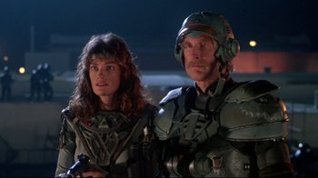 Movie still from “Masters of the Universe” (1987), directed by Gary Goddard – A man and a woman standing next to each other; Medium shot, Low angle