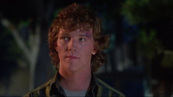 Movie still from “Masters of the Universe” (1987), directed by Gary Goddard – A young man with curly red hair looking up at the sky; Close Up shot, Low angle